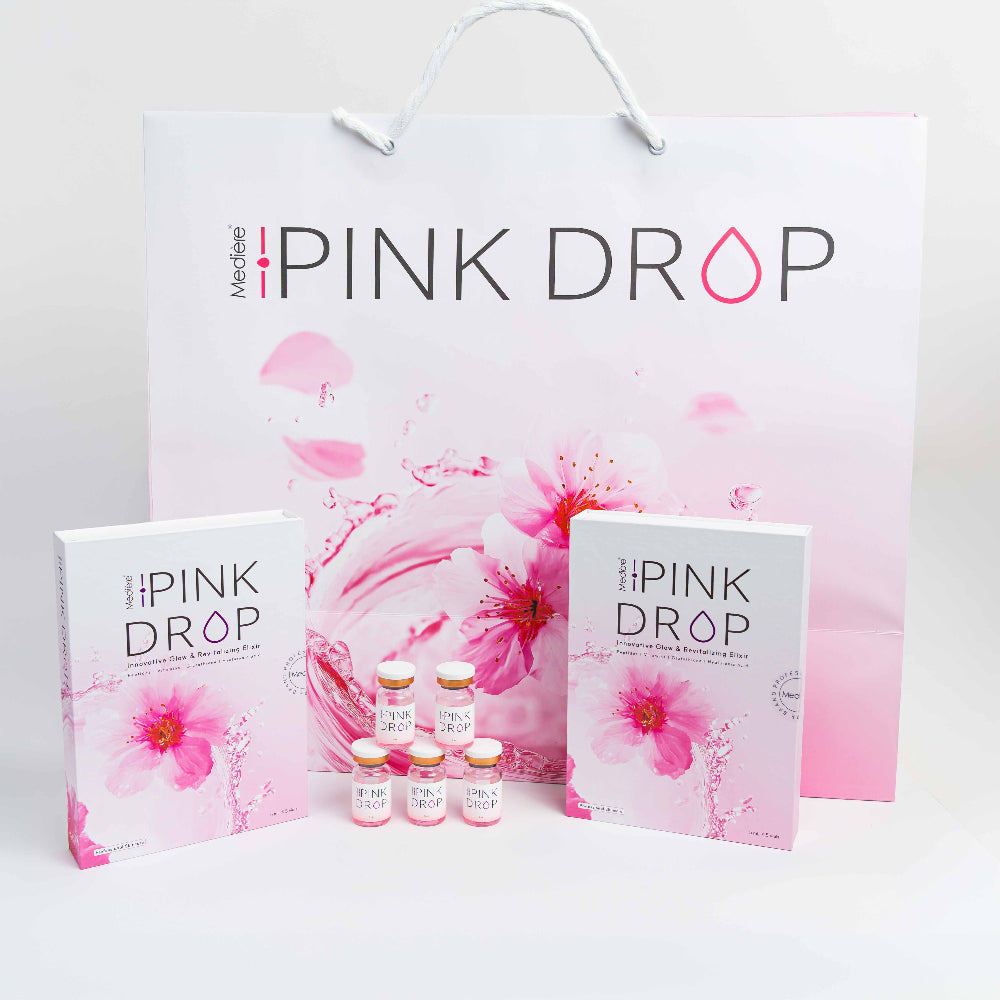 A skin booster set featuring a large white and pink shopping bag, two white product boxes with pink floral designs, and five small vials with pink caps, all branded 'PINK DROP'.