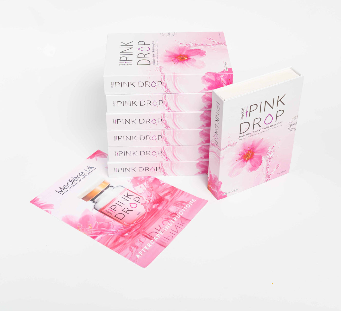 Boxes and packets of 'The Pink Drop' on a white background