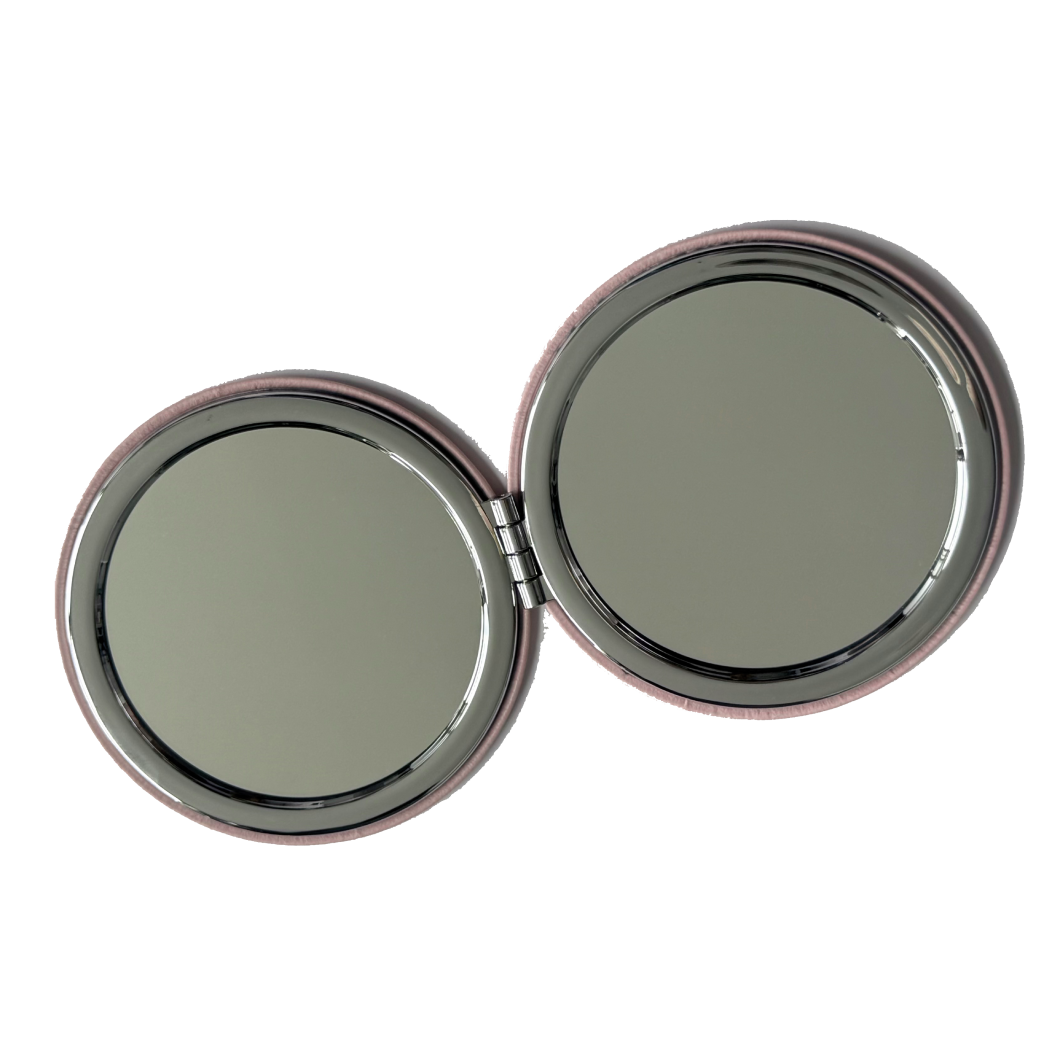 Compact mirror with two round reflective surfaces on a white background