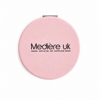 Pink compact mirror with 'Medière UK' branding on a white background