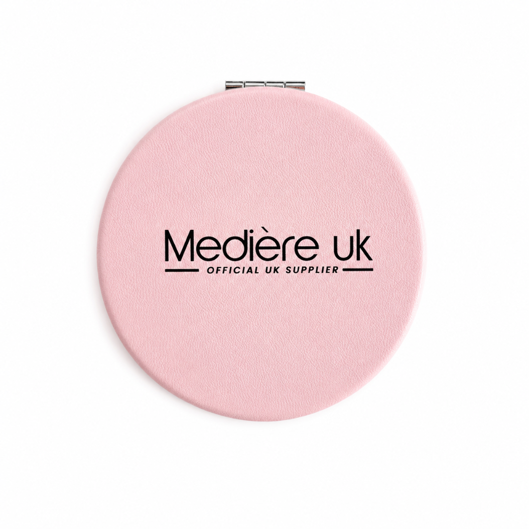 Pink compact mirror with 'Medière UK' branding on a white background