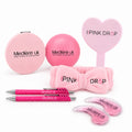 Collection of pink drop accessories with branding on a white background.
