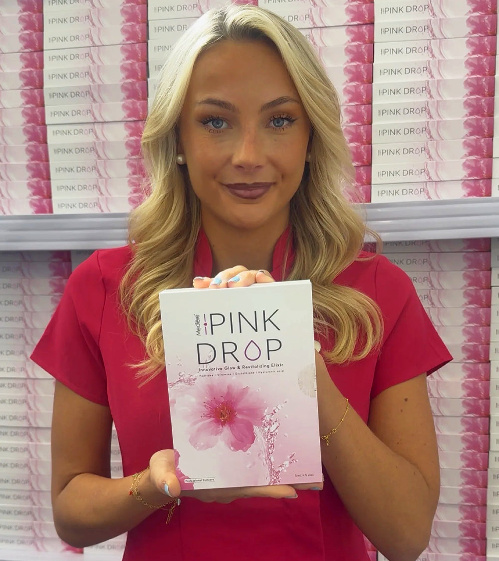woman holding Pink Drop skin booster treatment for professionals with the product on the shalving in the background too 