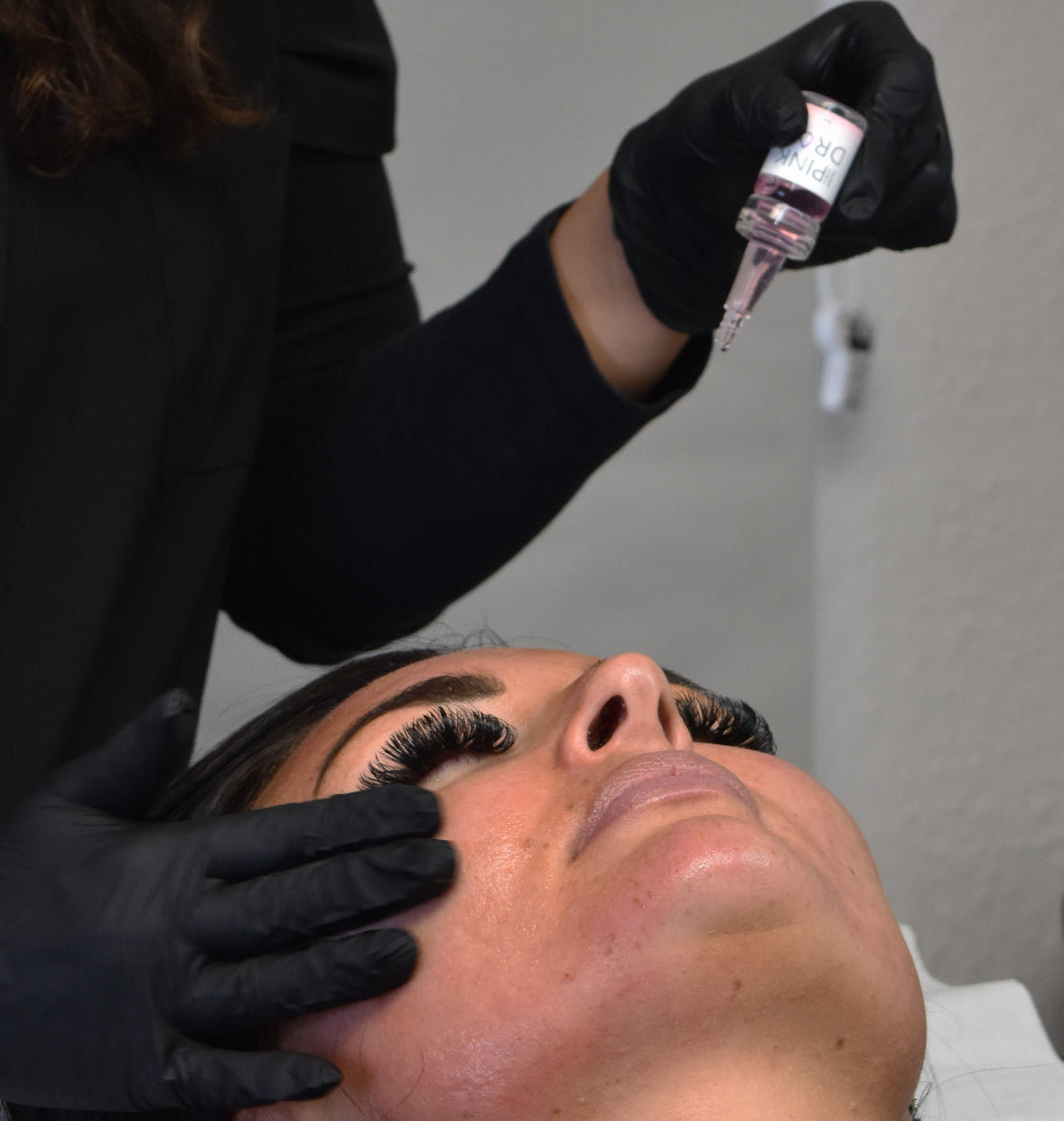 pink drop skin booster treatment in progress on a womans face