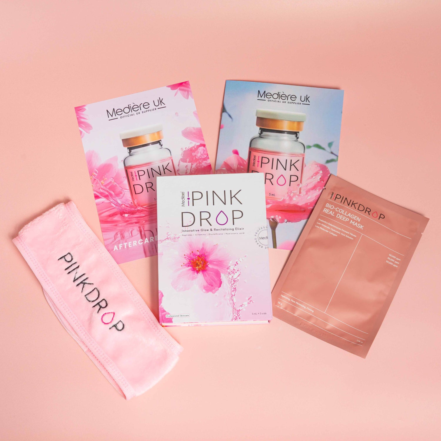 Collection of Pink Drop skincare products on a pink background